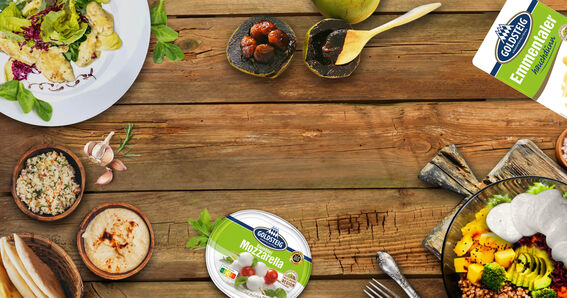 Food trends 2024 on a wooden table with Mozzarella Bambini Mini and wafer-thin Emmental cheese from GOLDSTEIG